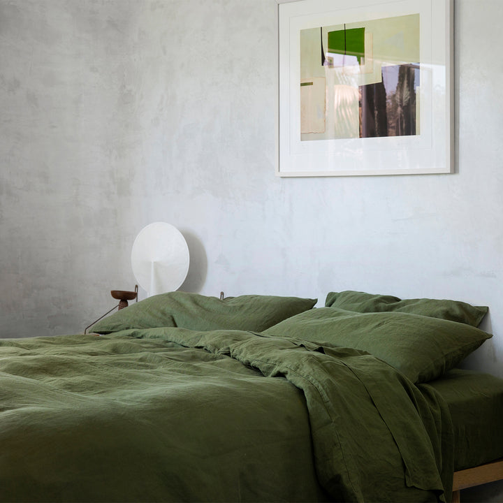 A bed dressed in Forest bed linen, styled with contemporary artwork. Sizes: Single, Double, Queen, King
