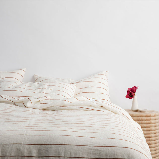A bed dressed in Cedar Stripe bed linen. Sizes: Single, Double, Queen, King