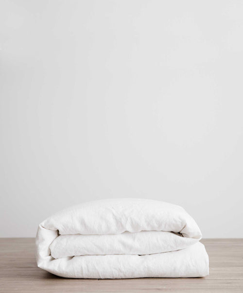Linen Duvet Cover - White folded neatly on wooden surface, showcasing breathable sustainable European Flax linen quality