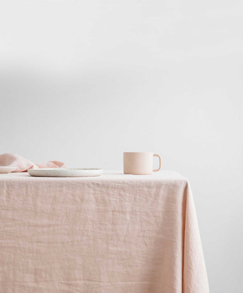 Linen Tablecloth - Blush soft natural fabric draped over table with matching blush ceramic cup and plate The beauty of home