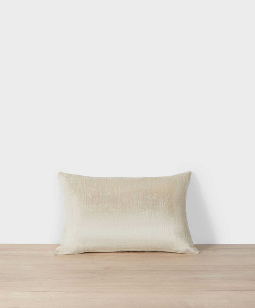 Talik Velvet Rectangular Cushion Cover - Cream placed on light wood surface showcasing soft velvet texture The beauty of home