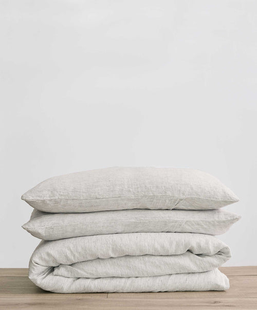 DUVET SET Single Pinstripe UK folded on wood surface, showcasing breathable natural linen with subtle stripes