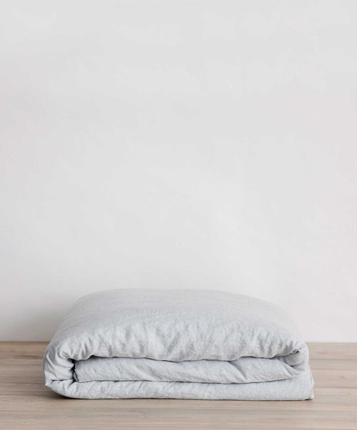 Linen Duvet Cover - Sky folded neatly on wooden surface highlighting soft breathable textile The beauty of home