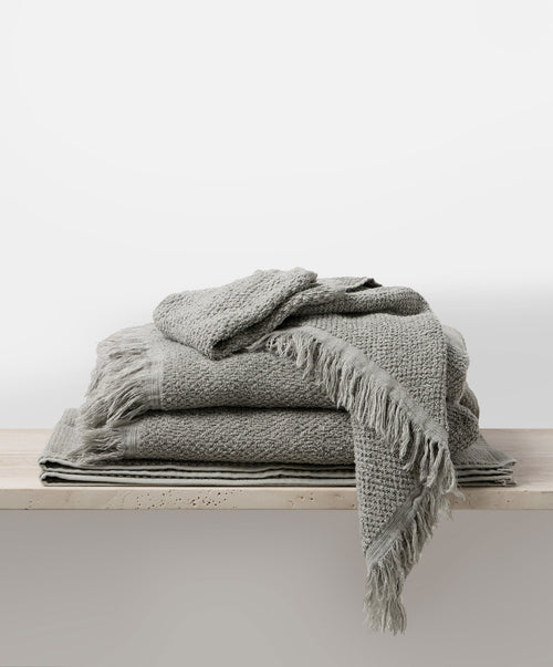 Pure Linen Towel Bundle - Pebble stacked on wooden surface with soft texture and natural breathable linen The beauty of home