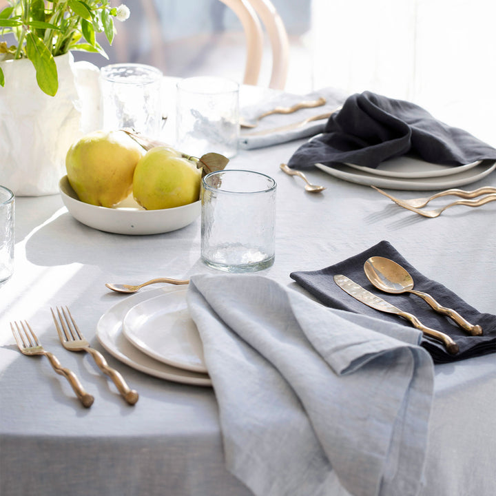 A table dressed with a Linen Tablecloth in Sky, and Linen Table Napkins in Sky and Slate.