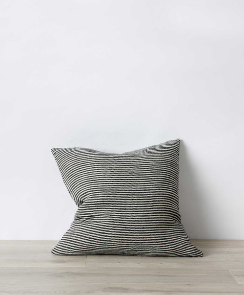 Mira Linen Cushion Cover - Ellis Stripe in natural tones on light wood floor with subtle striped texture The beauty of home