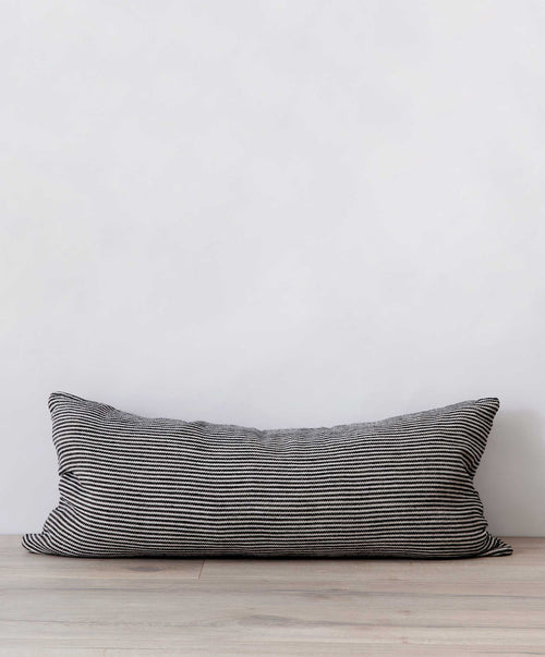Mira Lumbar Cushion Cover - Ellis Stripe in natural linen with subtle stripes resting on wooden floor The beauty of home