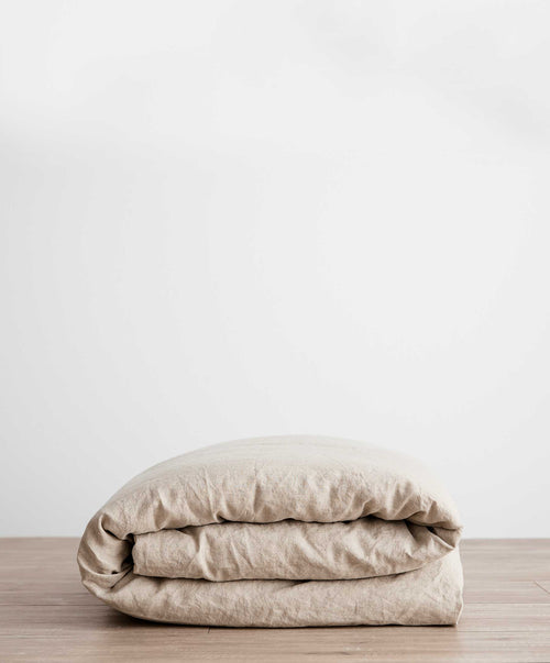 Linen Duvet Cover - Natural folded neatly on wooden surface with breathable sustainable European Flax™ linen The beauty of home