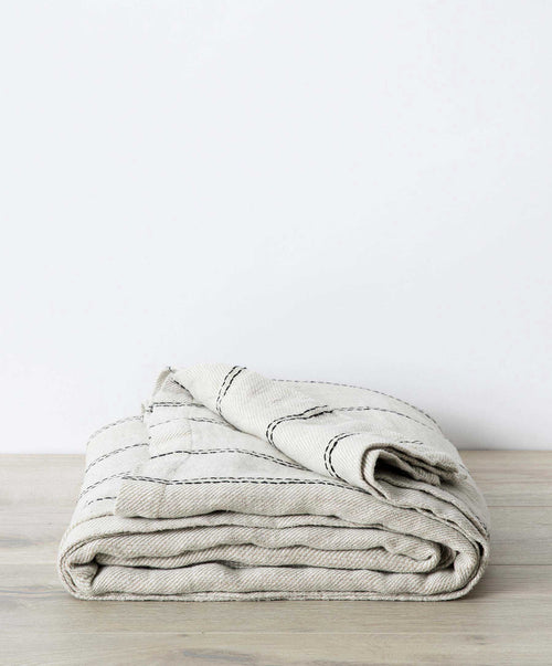 Mira Linen Bedcover - Ana folded natural linen with subtle black stripes, breathable, sustainable luxury The beauty of home