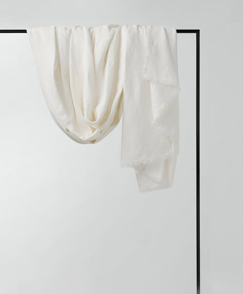 Freya Linen Throw - Snow in soft white linen hanging gracefully with delicate fringed edges The beauty of home
