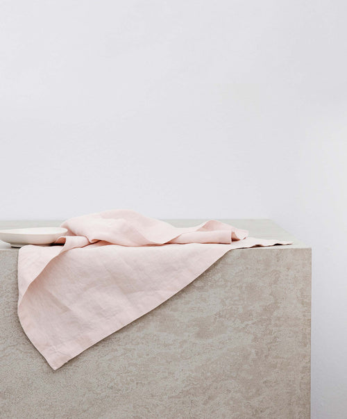Dining Edit - Blush & Pencil Stripe linen napkin softly arranged on a textured surface The beauty of home