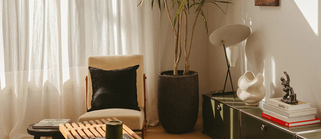 Modern living room with a chair, coffee table, and decorative items.