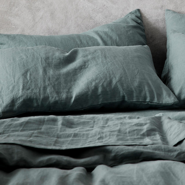 A close up on the Set of 2 Linen Pillowcases and Duvet Cover Set in Bluestone on a bed.						