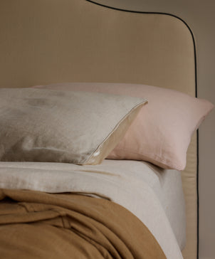 Bedroom Edit - Sand, Blush & Natural linen bedding layered on a neutral upholstered bed The beauty of home