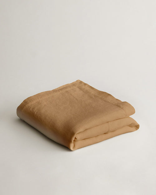 Heavyweight Linen Bedcover - Sand folded neatly to showcase its warm neutral tone