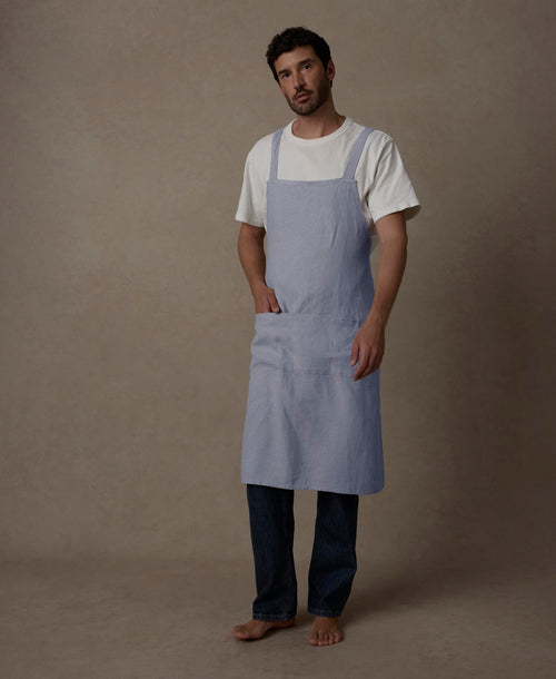 Man wearing Jude Linen Apron - Steel Blue in breathable, sustainable European Flax™ linen The beauty of home
