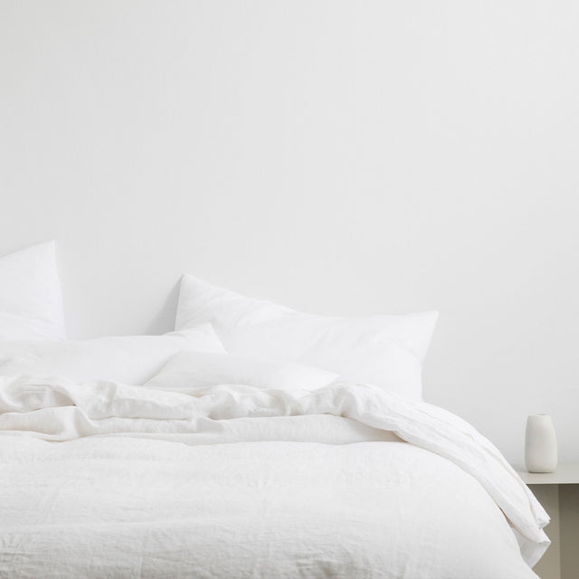 A bed dressed in White bedlinen. Sizes: Single, Double, Queen, King