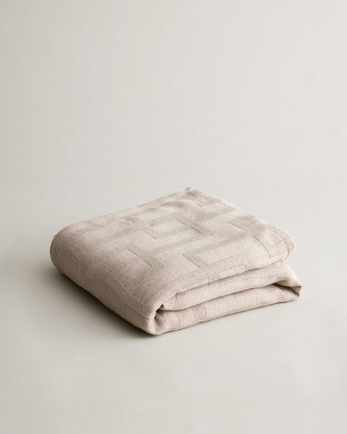 Rolfes Bedcover - Natural folded to show soft linen texture and subtle geometric stitching