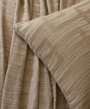 Close-up of beige textured fabric with a subtle pattern