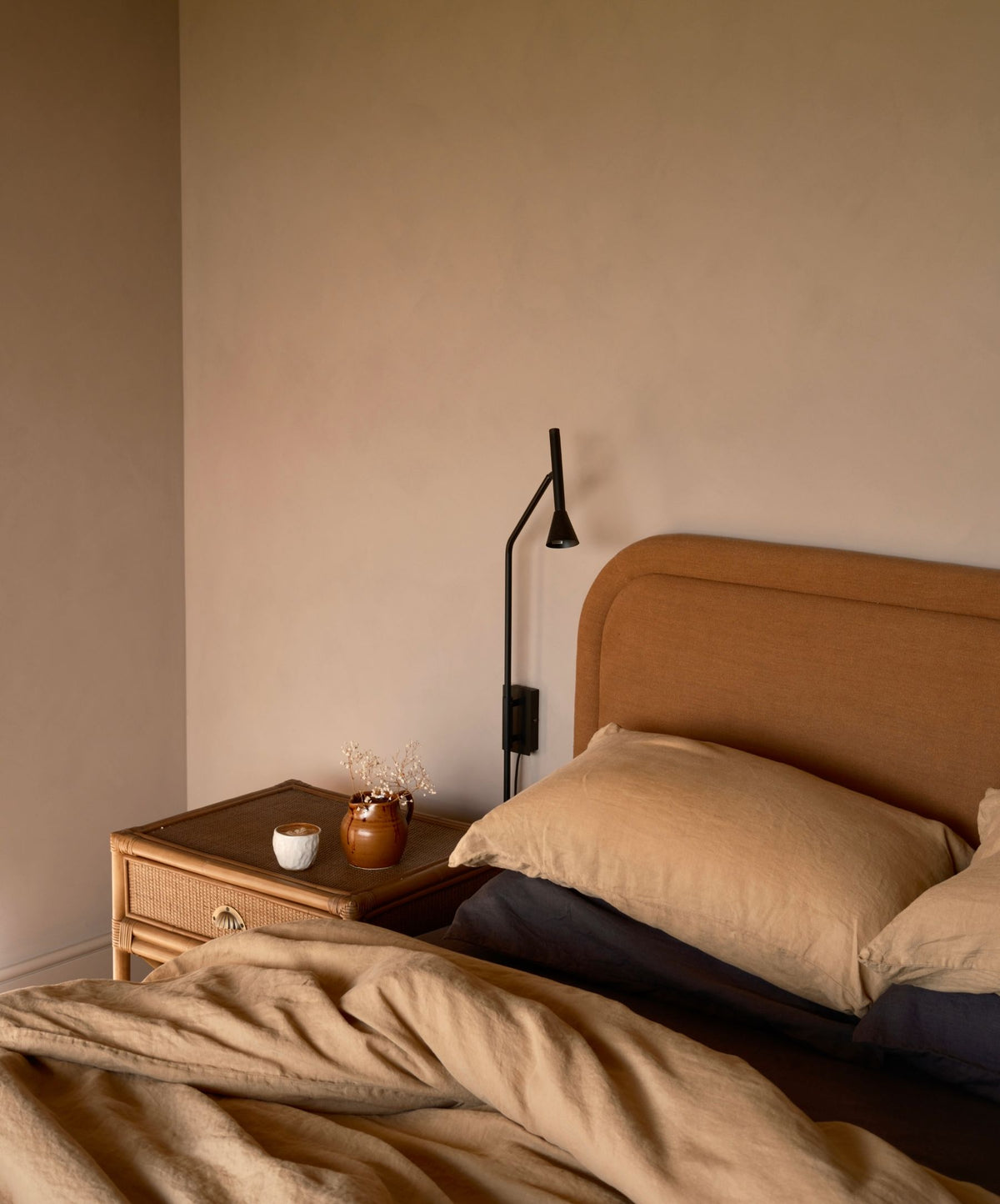 Linen Sheet Set with Pillowcases - Slate layered on bed with warm beige bedding and natural bedside decor