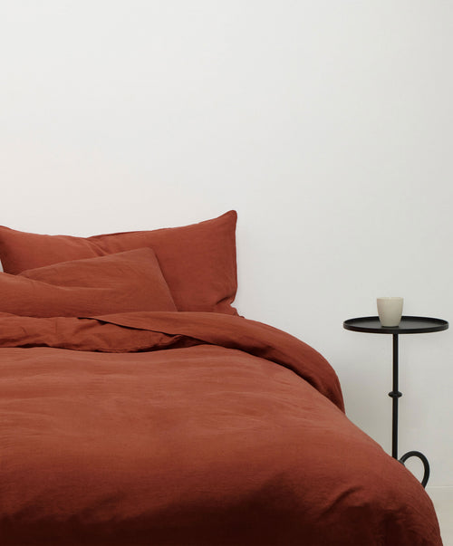 Linen Duvet Cover Set - Sienna in warm terracotta with soft breathable fabric on a minimalist bed The beauty of home