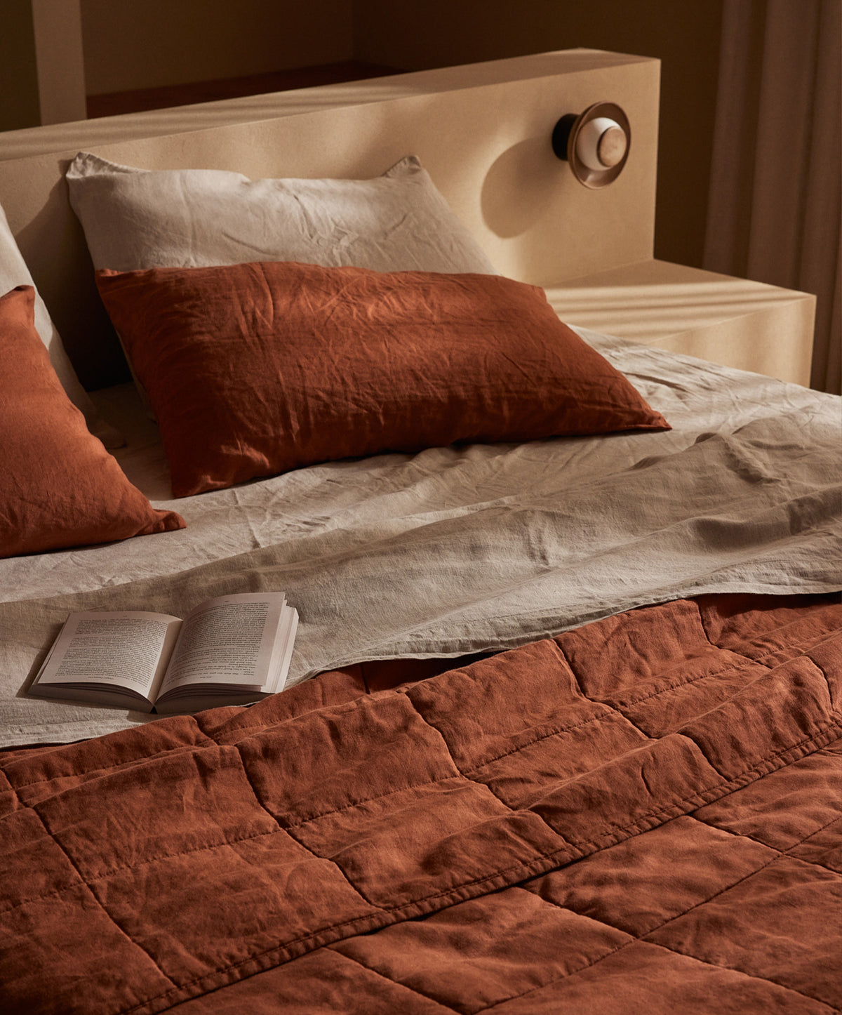 Quilted Bedcover - Sienna on natural linen bedding with a warm, earthy tone in a serene bedroom The beauty of home