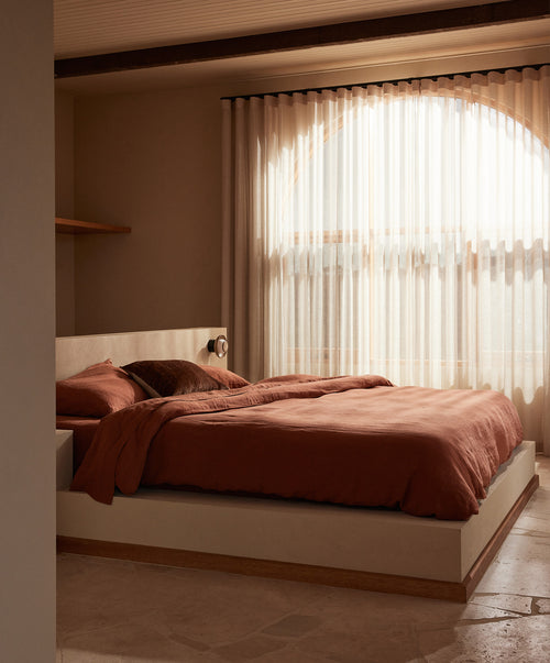 Talik Velvet Rectangular Cushion Cover - Chestnut adds warm, natural luxury to a serene, sunlit bedroom The beauty of home
