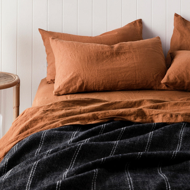 A bed dressed in Cedar bed linen with a Mira Bedcover in Rafa. Sizes: Queen, King