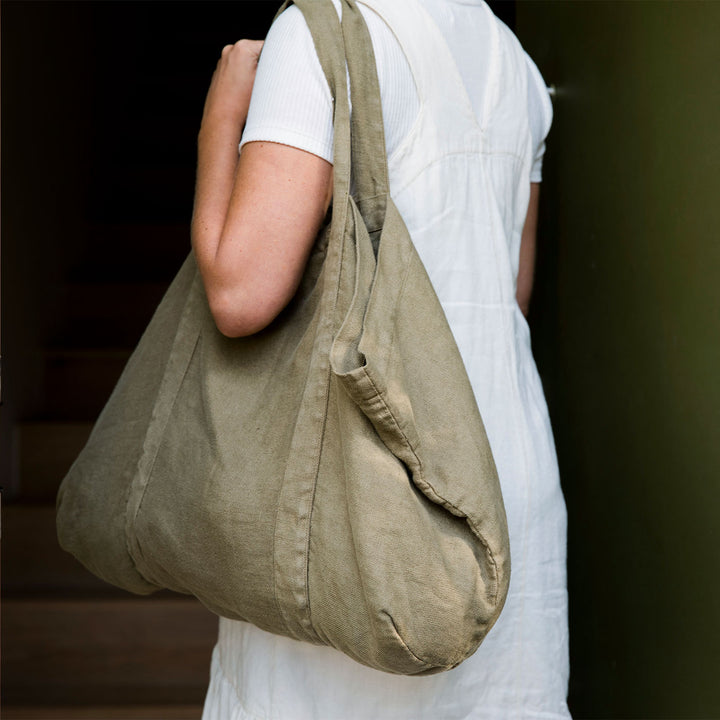A woman wearing a Frankie Linen Bag in Olive