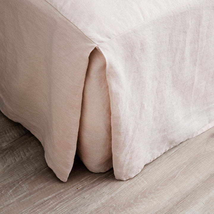A close up of the corner of the Linen Valance in Blush. Sizes: Queen, King