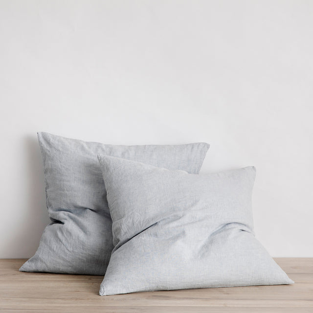 2 Linen pillowcases in Sky perched against a wall